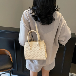 Vintage patterned beige handbag with M-letter monogram and crossbody strap for women