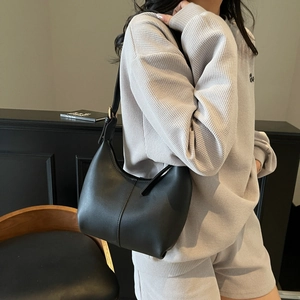 Minimalist black leather crescent hobo bag for women with adjustable shoulder strap
