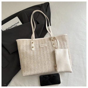 Detail of cream woven tote bag with matching coin purse and stylish gold stud accents