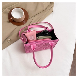 Pink quilted tote bag interior showing spacious capacity with smartphone and wallet