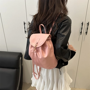 Pink PU leather minimalist backpack for women featuring a drawstring closure and gold buckles