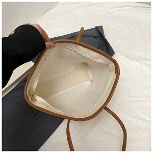 Detailed view of the spacious interior with a zippered pocket in a white tote bag