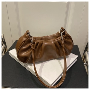 Detailed close-up of dark brown pleated cloud bag with silver metallic hardware buckle
