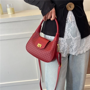 Chic burgundy woven leather crescent handbag with gold buckle and adjustable shoulder strap