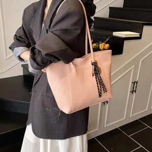 Pink lychee texture leather tote bag for women with woven tassel and long shoulder strap