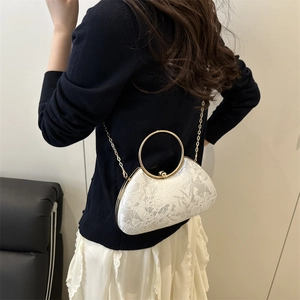 Elegant white lace evening handbag with golden ring handle and metal chain strap