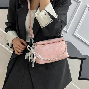 Pink snakeskin textured crossbody box bag with lace pearl bow charm and chain detail