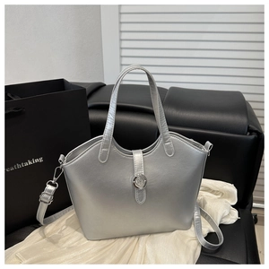 Detailed view of silver metallic bucket bag with adjustable strap and chrome buckle
