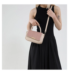 Chic beige crossbody bag featuring woven herringbone flap and elegant gold-tone lock