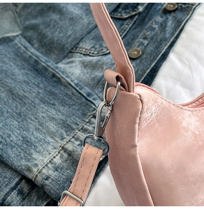 Detailed close-up of pink hobo bag featuring premium silver hardware and natural leather texture