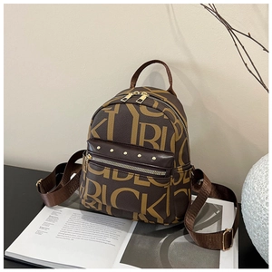 Detail view of mini backpack with letter print, golden rivets and polished hardware