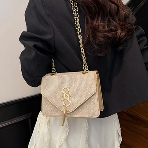 Champagne gold glitter crossbody bag with chain strap and tassel detail for women