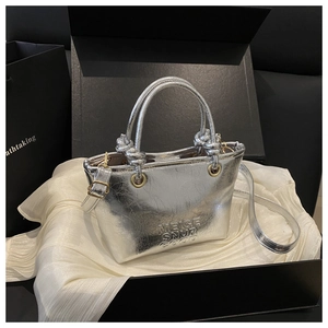 Silver crackle leather bucket bag with top handles in a luxury black gift box display