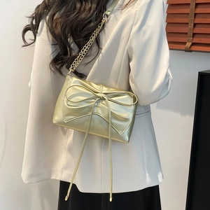 Sac fourre-tout doré avec nœud et chaîne métallique pour un style élégant au quotidien