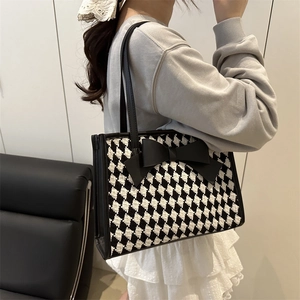 Sac fourre-tout à carreaux avec grand nœud noir et longues bretelles sur modèle