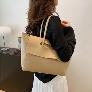 Minimalist beige tote bag in high-quality faux leather with a modern handle design
