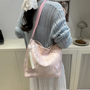 Pink lace tote bag featuring butterfly embroidery, long tassel and pearl charm details