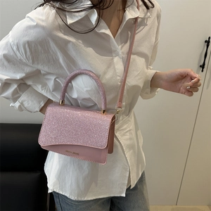 Pink sequined small square crossbody bag with miss.mini lettering on light outfit