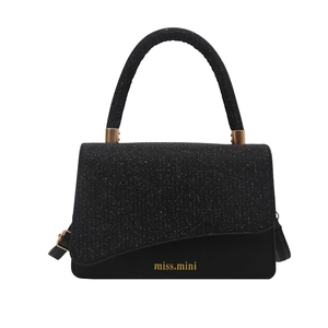 Elegant black handbag with glitter flap and gold branding on white background