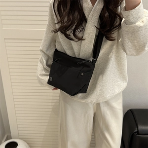 Minimalist black lightweight crossbody bag with wide strap for casual daily use
