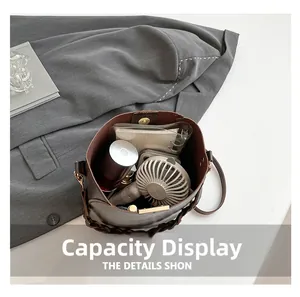 Top view of dark brown leather bucket bag showing large interior storage for daily items