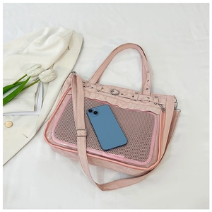 Pink minimalist nylon tote bag with mesh pocket shown next to a smartphone for size scale
