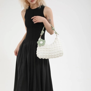 White quilted bubble fabric underarm bag with light green knot handle and flower charm