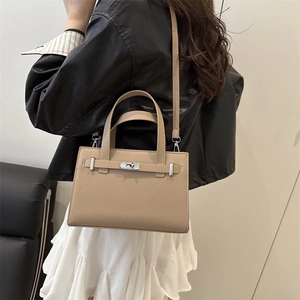 Classic beige pebbled leather square handbag with metal twist lock and shoulder strap