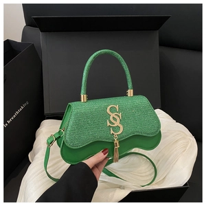 Detail of green woven leather handbag with gold SS buckle and fringe in gift box