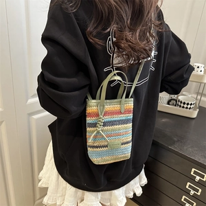Bohemian colorful woven mini crossbody bag with leather strap shown on a model