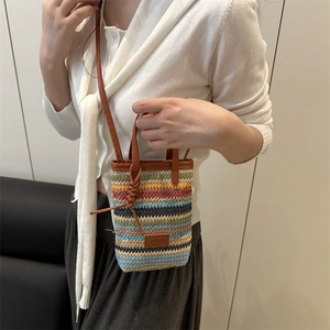 Mini multi-color woven straw crossbody bag with brown leather straps and fashion label
