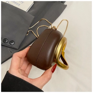 Detail of a structured dark brown mini handbag featuring a matte gold ring handle and chain