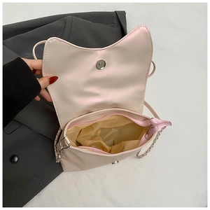 Detail of pink cat-ear bag interior with magnetic closure and zip pocket