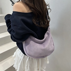 Lavender corduroy crescent tote bag shown in a stylish over-the-shoulder view