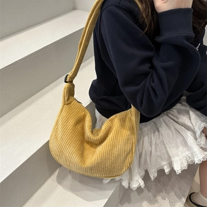 Bright yellow corduroy half-moon tote bag with adjustable strap for women