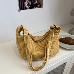 Large mustard yellow corduroy hobo tote bag for women in a cozy lifestyle setting