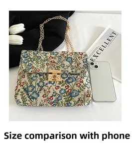 Floral jacquard shoulder bag with gold chain strap and size comparison with phone