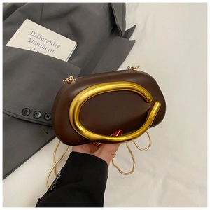 Detail of coffee leather evening bag with large gold C-handle and fine chain strap