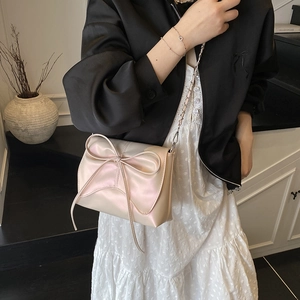 Pink pearl faux leather shoulder bag with large bow and metal chain strap for women
