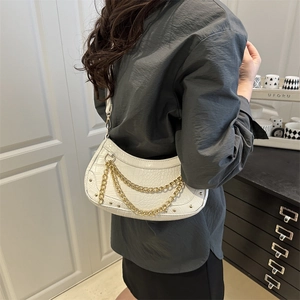 White crescent underarm bag with gold chain and crocodile texture on a female model