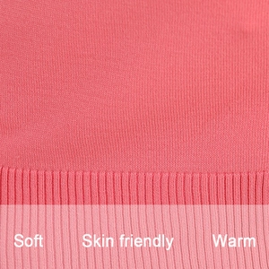 Macro detail of soft pink knit fabric texture with ribbed hem for maternity cardigan
