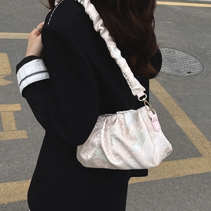 Pink pleated cloud underarm bag with traditional embroidery and wide shoulder strap