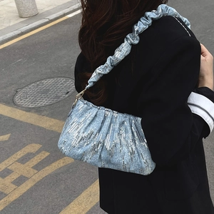 Light blue sequined bucket bag with ruffled handle in a modern Chinese style on street