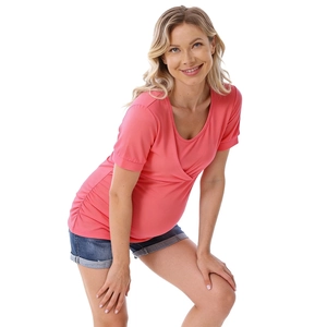 Detail of coral maternity nursing top featuring ruched sides and crossover neckline design