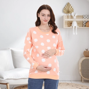 Orange maternity long sleeve nursing sweatshirt with white apple patterns and ribbed cuffs
