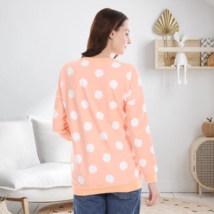 Pink nursing sweatshirt with polka dot print shown from a back view on a model
