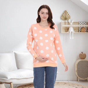 Pink maternity sweatshirt with white apple patterns and hidden nursing opening