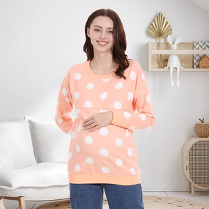 Detail of concealed nursing zipper on soft coral pink polka dot cotton sweatshirt