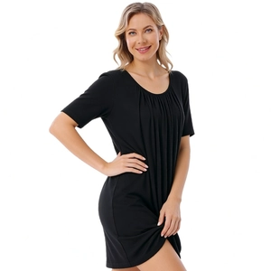Close-up of the pleated crew neck design on a soft black modal maternity nursing dress