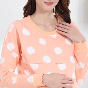 Detail of peach cotton nursing sweatshirt with apple patterns and hidden nursing zipper